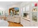 Elegant bar area with custom cabinetry, glass display cases, and a unique arched design with a mural at 2658 Davis St, Raleigh, NC 27608