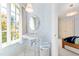 Bathroom with vintage style sink, bright natural light, and blue cloud wallpaper at 2658 Davis St, Raleigh, NC 27608