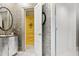 Elegant bathroom featuring a stylish vanity with a vessel sink, patterned wallpaper, and a glass-enclosed shower at 2658 Davis St, Raleigh, NC 27608
