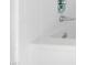 Close-up of a white tiled bathtub featuring chrome fixtures, offering a clean and modern bathing experience at 2658 Davis St, Raleigh, NC 27608