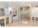 Bright bathroom with marble flooring, glass enclosed shower, and double vanity at 2658 Davis St, Raleigh, NC 27608