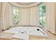 Soaking tub with bright natural light from the bay window at 2658 Davis St, Raleigh, NC 27608