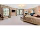 Large bedroom with a fireplace, mounted TV, decorative curtains, and ample space at 2658 Davis St, Raleigh, NC 27608