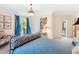Bright bedroom featuring blue accents, a zebra-print pillow, chandelier lighting, and a decorative seating area at 2658 Davis St, Raleigh, NC 27608