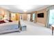 Spacious bedroom featuring a comfortable bed, a fireplace, plenty of light, and access to en suite areas at 2658 Davis St, Raleigh, NC 27608