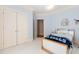 Bright bedroom with blue walls, white trim, and double closet at 2658 Davis St, Raleigh, NC 27608