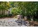 Elegant brick driveway leading to a stately home, complemented by manicured landscaping and mature trees at 2658 Davis St, Raleigh, NC 27608