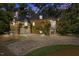 Stunning stone home featuring a circular driveway, ivy covered walls, and a beautiful balcony at 2658 Davis St, Raleigh, NC 27608