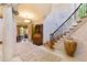 Elegant foyer featuring staircase with wrought iron railing and stone columns at 2658 Davis St, Raleigh, NC 27608