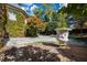 Landscaped front yard featuring mature trees and decorative concrete pots, a stunning entrance at 2658 Davis St, Raleigh, NC 27608