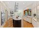 Bright, updated kitchen with island, stainless appliances, and arched doorway to bar area at 2658 Davis St, Raleigh, NC 27608
