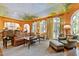 Bright living room with decorative ceiling paint, hardwood flooring, large windows, and multiple seating areas at 2658 Davis St, Raleigh, NC 27608