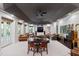 Spacious living room with a tray ceiling, multiple seating areas, neutral carpet, and modern recessed lighting at 2658 Davis St, Raleigh, NC 27608