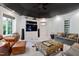 Comfortable living room featuring built-in shelving, a large TV, and cozy seating arrangement at 2658 Davis St, Raleigh, NC 27608
