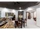 Cozy living room with a black tray ceiling, dining table, and comfortable seating arrangement at 2658 Davis St, Raleigh, NC 27608