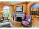 Living room featuring a fireplace, hardwood flooring, and a painted ceiling with archway to the adjacent room at 2658 Davis St, Raleigh, NC 27608
