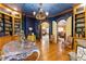 Home office showcasing custom built-in shelves, unique ceiling paint, hardwood flooring, and a decorative table at 2658 Davis St, Raleigh, NC 27608