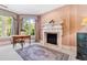 Cozy office space featuring a fireplace, natural light, and a desk for work or study at 2658 Davis St, Raleigh, NC 27608