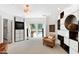 Well-lit office with custom shelving, entertainment center and comfortable seating area at 2658 Davis St, Raleigh, NC 27608