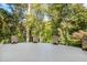 Large outdoor patio surrounded by green foliage, offering a private and serene outdoor space at 2658 Davis St, Raleigh, NC 27608
