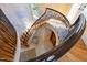 Elegant staircase with black iron railings, light wood steps, and a beautiful window view at 2658 Davis St, Raleigh, NC 27608
