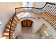 Unique staircase design with hardwood steps, wrought iron railings, and custom ceiling work at 2658 Davis St, Raleigh, NC 27608