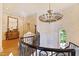 Staircase landing with a chandelier, chest with mirror, antique chair, and decorative wall at 2658 Davis St, Raleigh, NC 27608