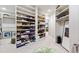 Spacious walk-in closet with shelving, mirrored door, and ample storage space for clothing and accessories at 2658 Davis St, Raleigh, NC 27608