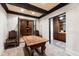 Wine cellar with a wooden table, dark wooden ceiling beams, and wine racks visible through the doorway at 2658 Davis St, Raleigh, NC 27608