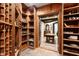Wine cellar entrance with wine racks on left side, open to another room with wooden table and chairs at 2658 Davis St, Raleigh, NC 27608