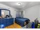 Bedroom featuring blue walls, a comfortable bed, and a modern desk area for work or study at 2728 Old Milburnie Rd Rd, Raleigh, NC 27604
