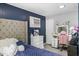 Well-lit bedroom featuring a tufted headboard, vanity, and gray walls, creating a peaceful retreat at 2728 Old Milburnie Rd Rd, Raleigh, NC 27604