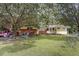 Charming home featuring a brick facade, lush lawn, and mature trees, creating a welcoming exterior at 2728 Old Milburnie Rd Rd, Raleigh, NC 27604