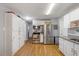 Modern kitchen features white cabinets, stainless steel appliances, granite countertops, and hardwood floors at 2728 Old Milburnie Rd Rd, Raleigh, NC 27604