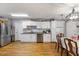 Spacious kitchen and dining area with white cabinets, stainless steel appliances, and hardwood floors at 2728 Old Milburnie Rd Rd, Raleigh, NC 27604