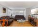 Inviting living room with leather sofas, hardwood floors, and a TV, creating a relaxing space at 2728 Old Milburnie Rd Rd, Raleigh, NC 27604