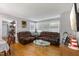 Comfortable living room featuring leather sofas, hardwood floors, and natural light, perfect for relaxation at 2728 Old Milburnie Rd Rd, Raleigh, NC 27604