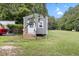 Newer shed with a fresh coat of gray paint in a grassy backyard under a sunny sky at 2728 Old Milburnie Rd Rd, Raleigh, NC 27604