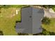 Aerial view of home showcasing dark roof amidst green lawns, mature trees, propane tank and secluded backyard fire pit at 276 Sagamore Dr, Louisburg, NC 27549