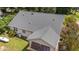 Aerial view of a home's roof highlighting its unique architecture, surrounded by lush greenery and a propane tank in the yard at 276 Sagamore Dr, Louisburg, NC 27549