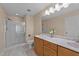 Bathroom boasts wood cabinets, marble countertop, and a glass-enclosed shower at 276 Sagamore Dr, Louisburg, NC 27549