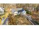 Exterior view of a home featuring a spacious two-car garage, complemented by mature landscaping and a paved driveway at 276 Sagamore Dr, Louisburg, NC 27549