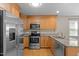 Well-lit kitchen with stainless steel appliances, granite countertops, and hardwood floors at 276 Sagamore Dr, Louisburg, NC 27549