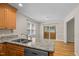 Eat-in kitchen featuring granite countertops, wood cabinets, stainless appliances, and natural light at 276 Sagamore Dr, Louisburg, NC 27549