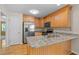 Modern kitchen with stainless steel appliances, granite countertops, and light wood cabinets at 276 Sagamore Dr, Louisburg, NC 27549