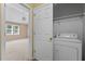 Conveniently located laundry closet with washer and dryer, next to a glimpse into a carpeted bedroom with a ceiling fan at 276 Sagamore Dr, Louisburg, NC 27549