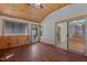 Bright living room boasts wood-paneled ceiling and walls, wood laminate flooring, and access to the kitchen at 276 Sagamore Dr, Louisburg, NC 27549