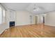 Living room with a cozy fireplace, vaulted ceiling, hardwood floors, and built-in shelving at 276 Sagamore Dr, Louisburg, NC 27549