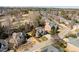 Expansive aerial view of a neighborhood with well-maintained lawns and mature trees, some adjacent to a green golf course at 3025 Osterley St, Raleigh, NC 27614
