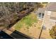 A fenced backyard with a covered deck, outdoor seating, and mature trees at 3025 Osterley St, Raleigh, NC 27614